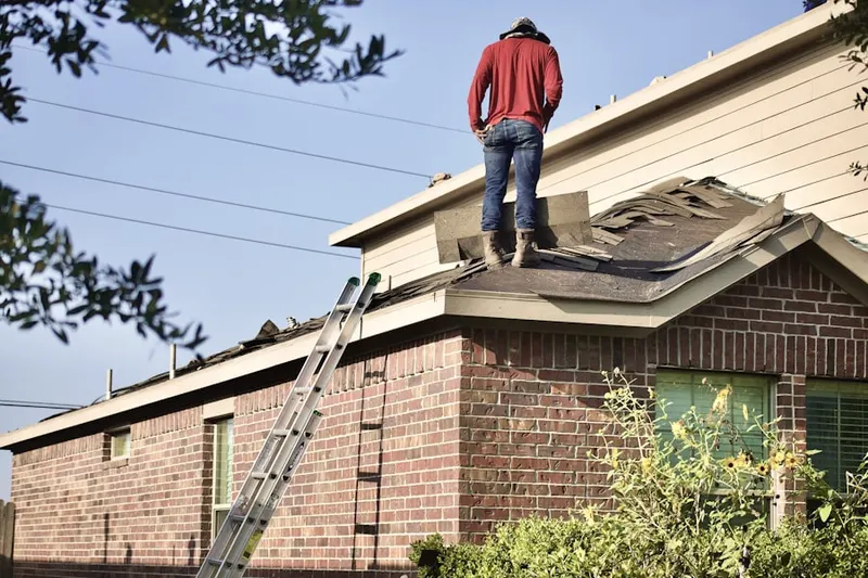 Professional roofer working on a residential roof in Monocacy Station